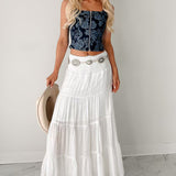 Lang, højtaljet A-formet nederdel med kontrasterende snøre, boheme-chic stil