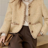 Elegant frakke i tofarvet tekstureret uld