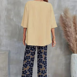 Chic sæt med asymmetrisk top og vide, blomstrede bukser til kvinder