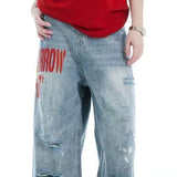 Brede jeans med falmet broderi