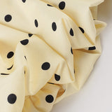 Tulipan minikjole med åben ryg og polkaprikket bælte