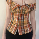 Kort ternet bluse, tætsiddende talje, bindebånd i halsen og knapper foran