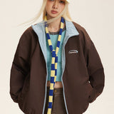 Vendbar jakke med opretstående krave og farveblokke