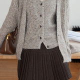 Højtaljet plisseret nederdel i ensfarvet uld