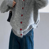Oversized cardigan med hjerteformede knapper og rund hals