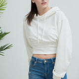 Kort hættetop, tætsiddende i taljen, afslappet stil.