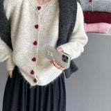 Oversized cardigan med hjerteformede knapper og rund hals