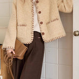 Elegant frakke i tofarvet tekstureret uld