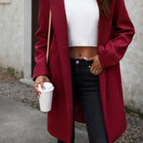 Lang, ensfarvet frakke i uldblanding