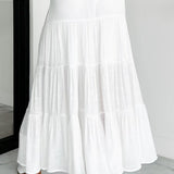 Lang, højtaljet A-formet nederdel med kontrasterende snøre, boheme-chic stil