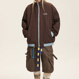 Vendbar jakke med opretstående krave og farveblokke