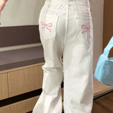 Lyserøde jeans med brede ben og broderet sløjfe