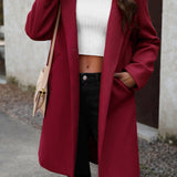 Lang, ensfarvet frakke i uldblanding