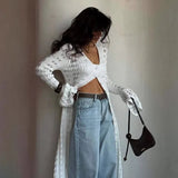 Langærmet strandvest med svaj i strik