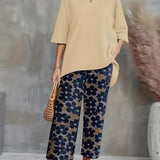 Chic sæt med asymmetrisk top og vide, blomstrede bukser til kvinder