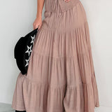 Lang, højtaljet A-formet nederdel med kontrasterende snøre, boheme-chic stil