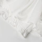 Mini A-formet nederdel med flæser og et lavtaljet bælte med farveblok