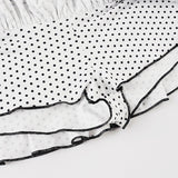 Bodysuit-miniskørt med flæser, polkaprikket patchwork og farveblokke.