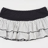 Bodysuit-miniskørt med flæser, polkaprikket patchwork og farveblokke.