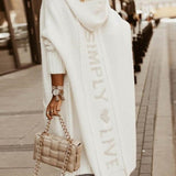 Lang damefrakke – Afslappet pasform – Strikket uld – Hætte – Grafisk ryg