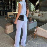 Todelt kontorsæt: vest med kontrasterende revers, lommer og bukser.