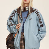 Vendbar jakke med opretstående krave og farveblokke