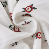 Todelt sæt: ærmeløs blomstertop og lavtaljet miniskørt