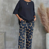 Chic sæt med asymmetrisk top og vide, blomstrede bukser til kvinder