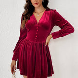 Kort, tætsiddende fløjlskjole med lange ærmer og V-hals, knappet