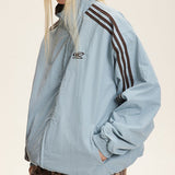 Vendbar jakke med opretstående krave og farveblokke