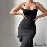 Elegant ærmeløs sommer-midikjole med flæser og åben ryg, pyntet med en sløjfe.