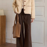 Elegant frakke i tofarvet tekstureret uld