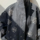 Højhalset frakke pyntet med perler og pailletter