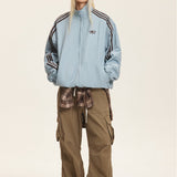 Vendbar jakke med opretstående krave og farveblokke