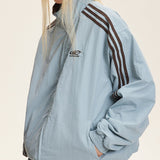 Vendbar jakke med opretstående krave og farveblokke