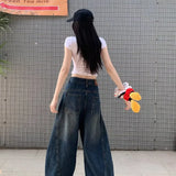 Casual utility jeans med vide, buede ben og en slidt look