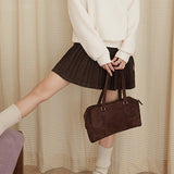 Højtaljet plisseret nederdel i ensfarvet uld