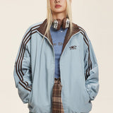 Vendbar jakke med opretstående krave og farveblokke