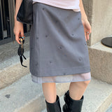 Mininederdel i mesh med broderi af blomster