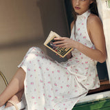 Todelt sæt: vest og maxinederdel med satinprint og pufkant