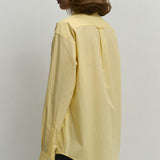Løstsiddende gul bomuldsbluse med knapper, ideel til hverdagsbrug.