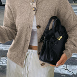 Minimalistisk cardigan med lange ærmer og knapper