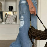 Lige, lavtaljede jeans med vide ben, slidt look og hjertemønster