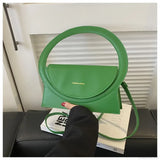 Luksuriøs skuldertaske i læder med rundt håndtag fra et eksklusivt mærke