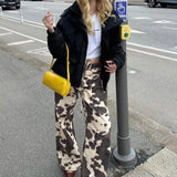 Elegante jeans med lige ben og vintage ko-print