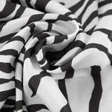 Højtaljet, draperet maxinederdel med zebraprint